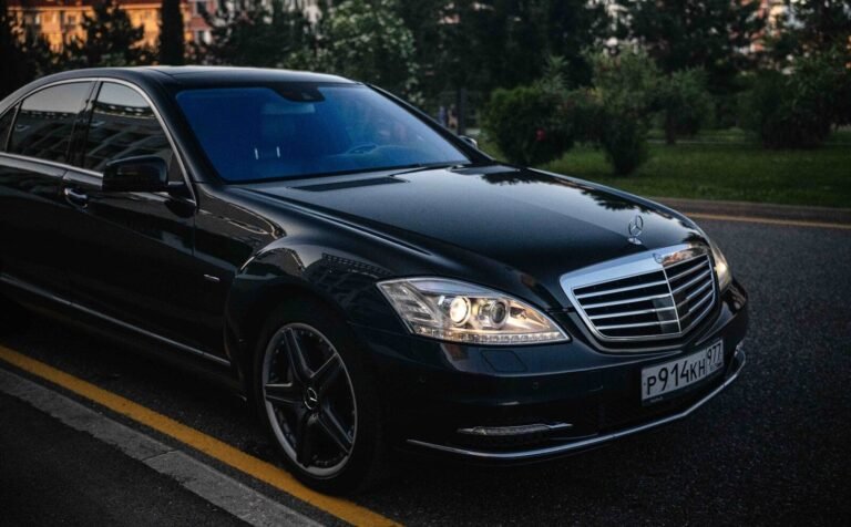 A black mercedes-benz s-class sedan driving on road