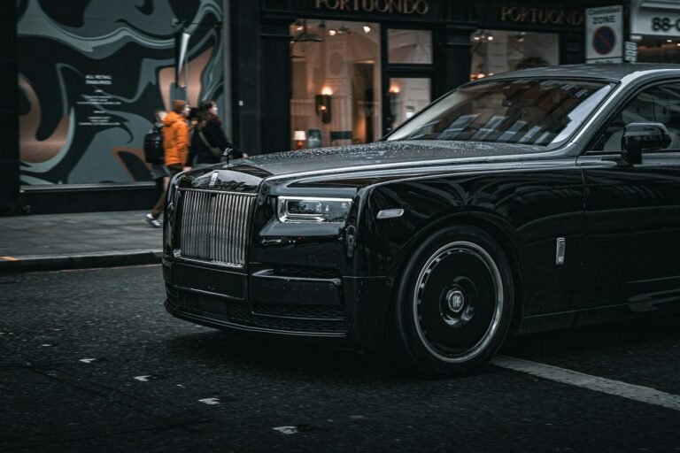 A black rolls royce parked on the side of the road